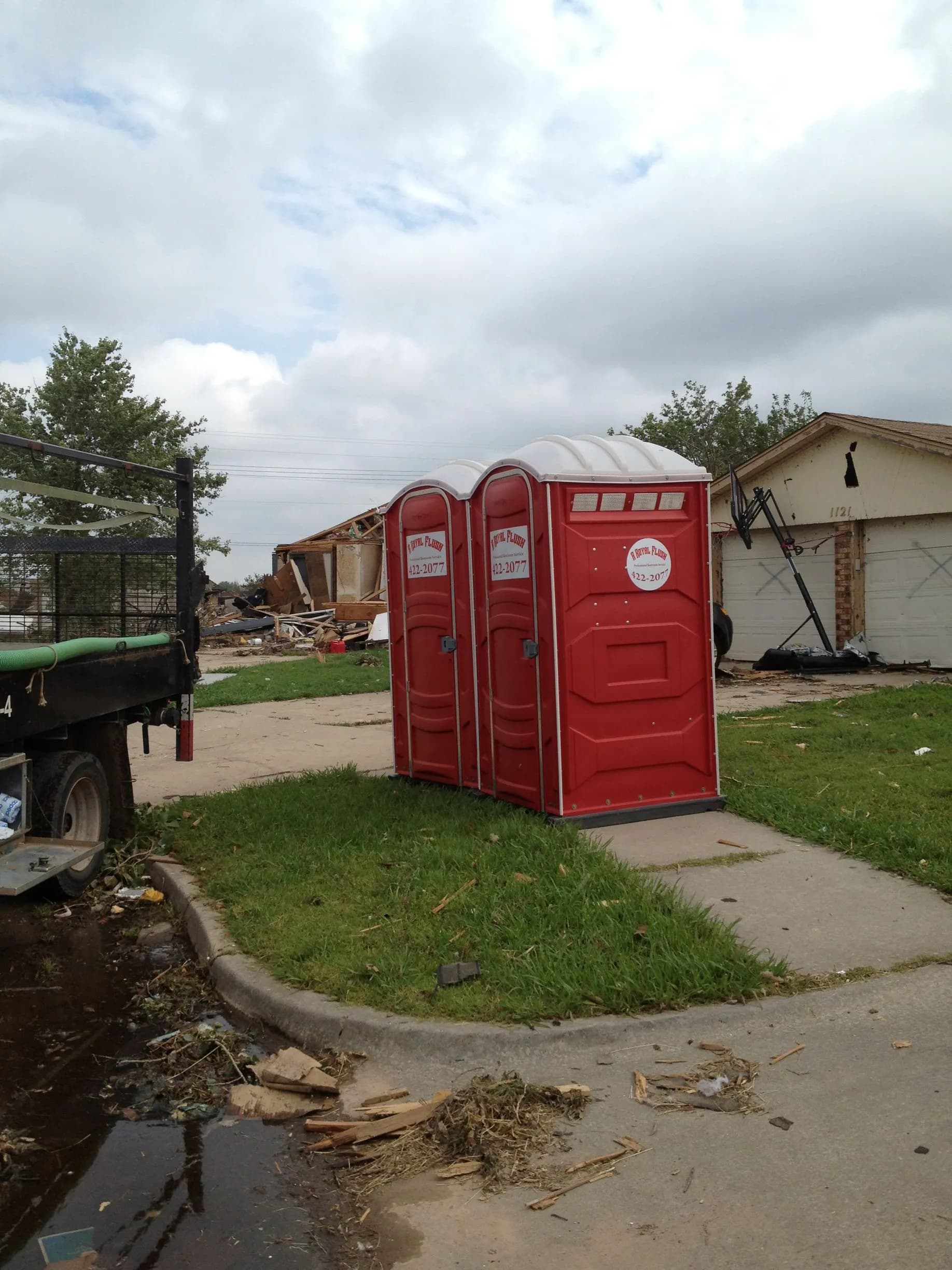 A wheelchair-accessible ADA portable restroom placed at a job site