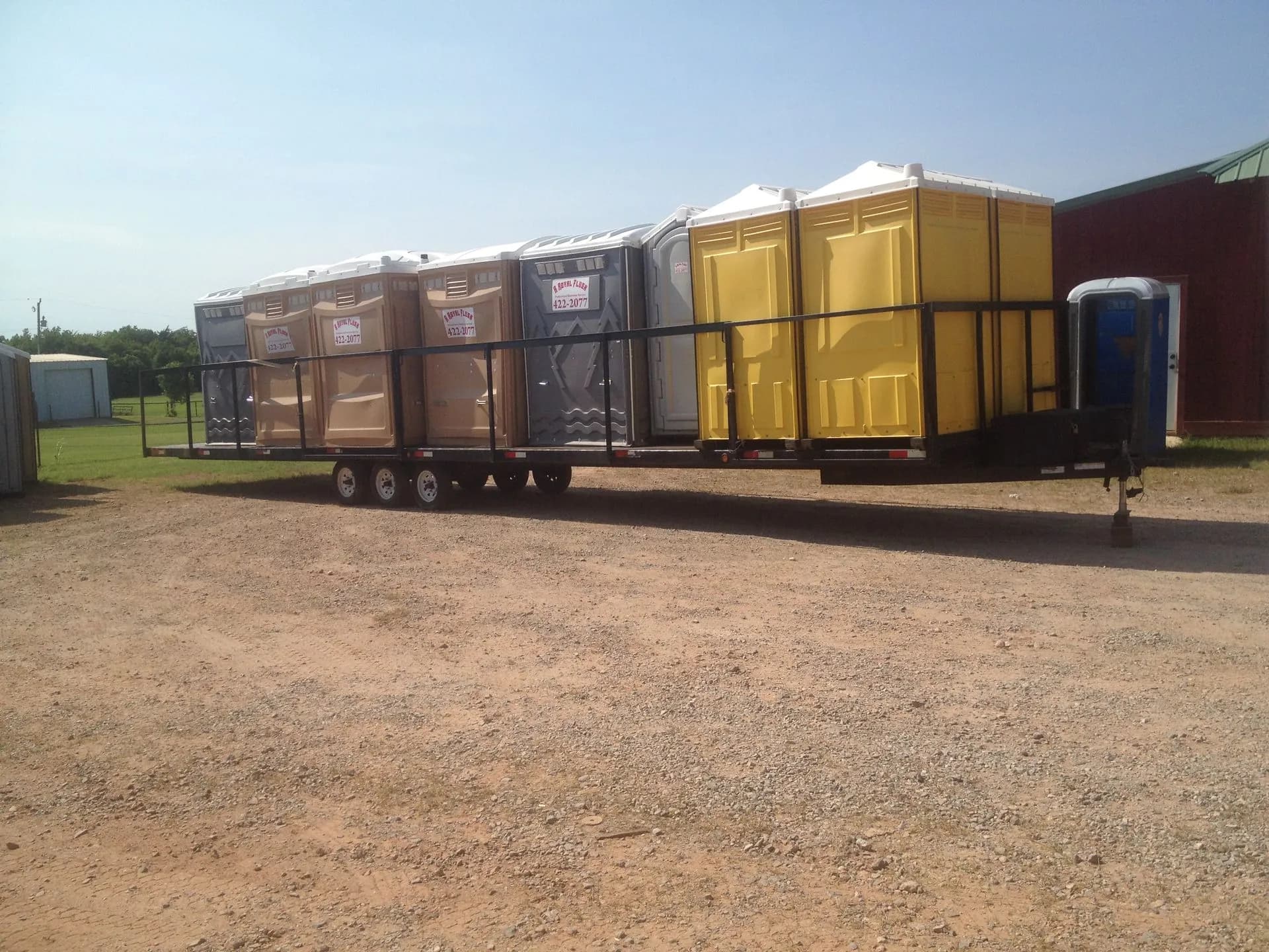 A Royal Flush delivery trailer loaded with portable restroom units