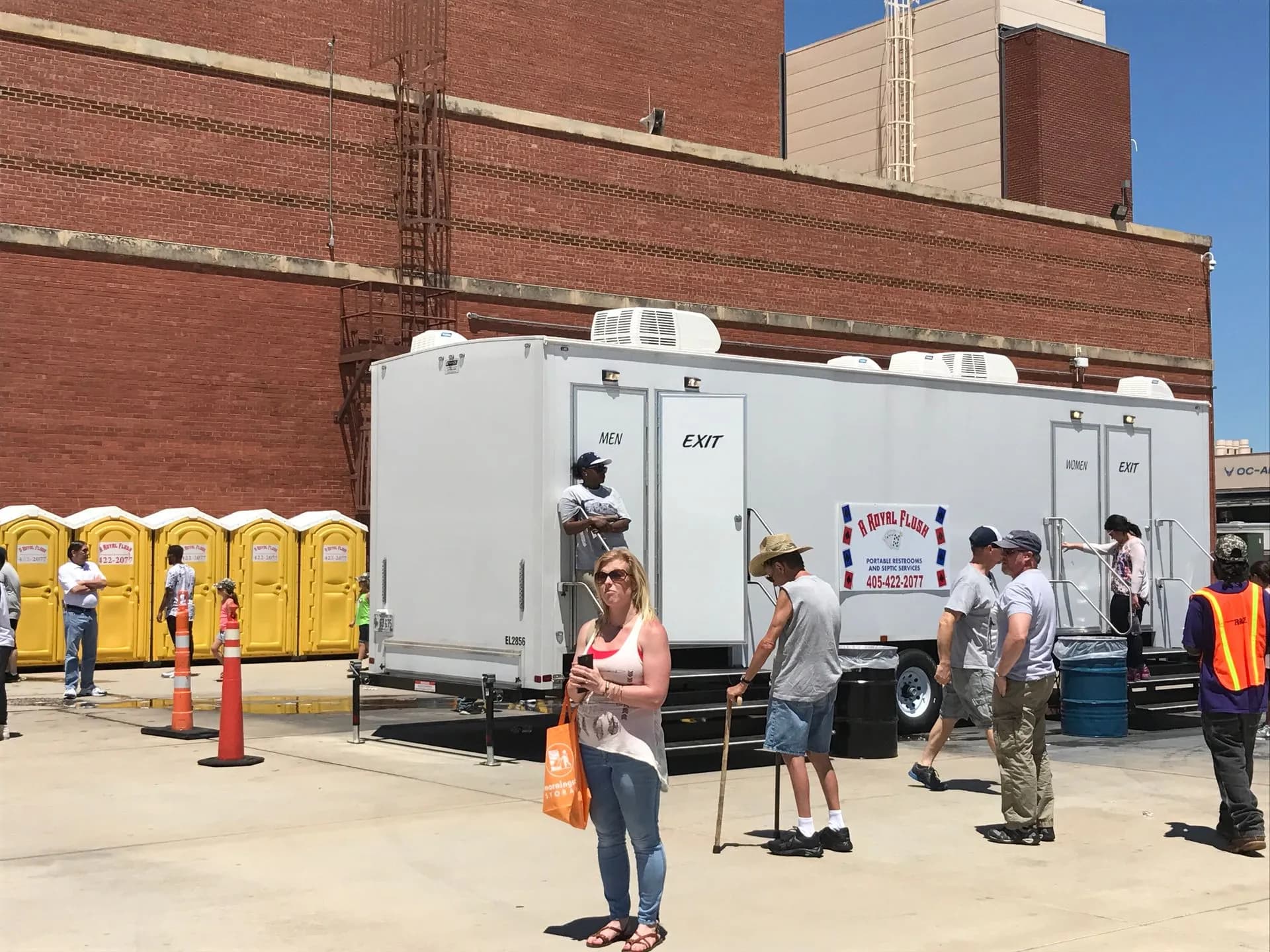 Guests using a VIP restroom trailer at a festival