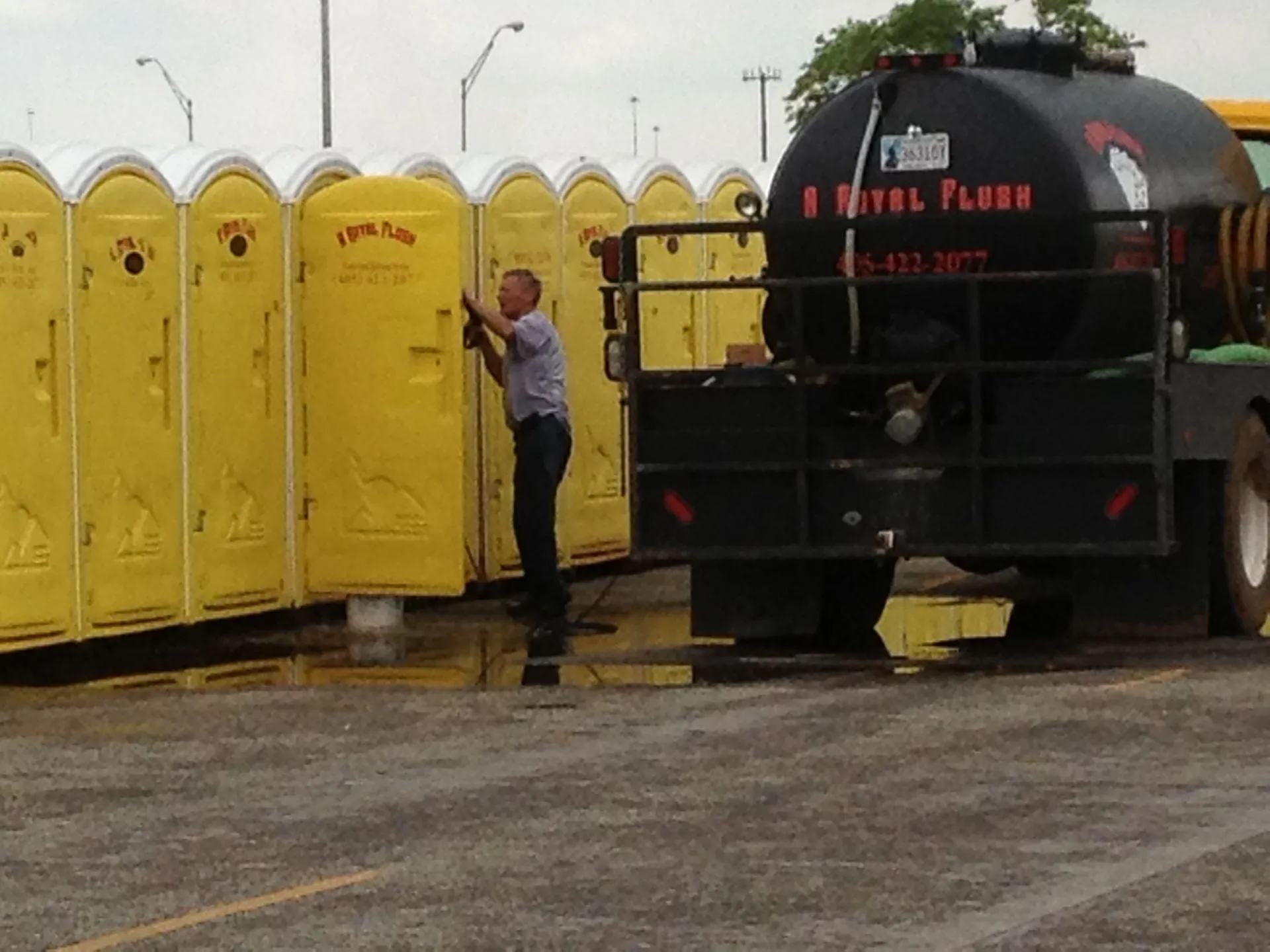 Pump truck servicing a row of portable toilets
