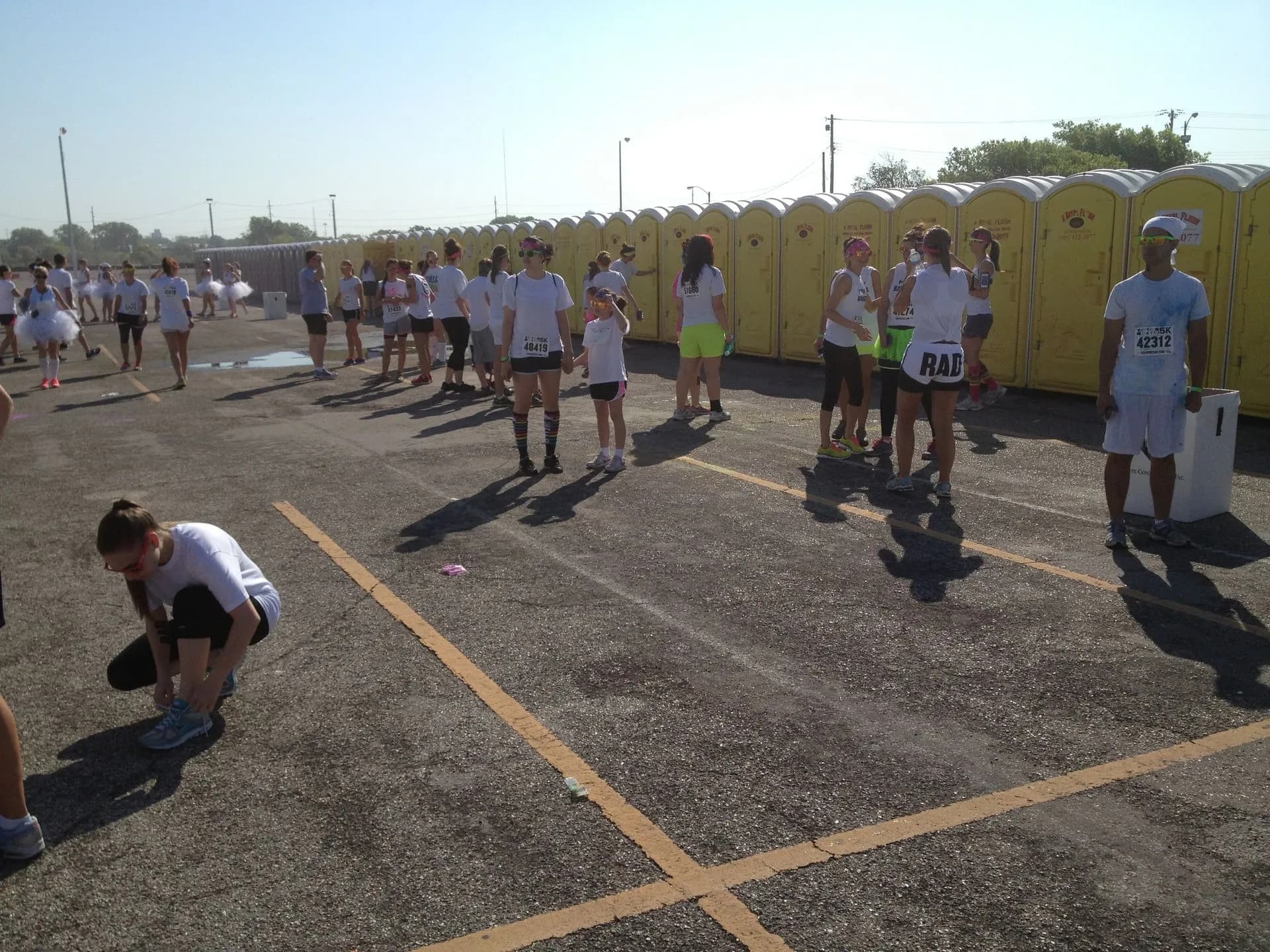 Runners gathered near a row of portable restrooms at an Oklahoma City race