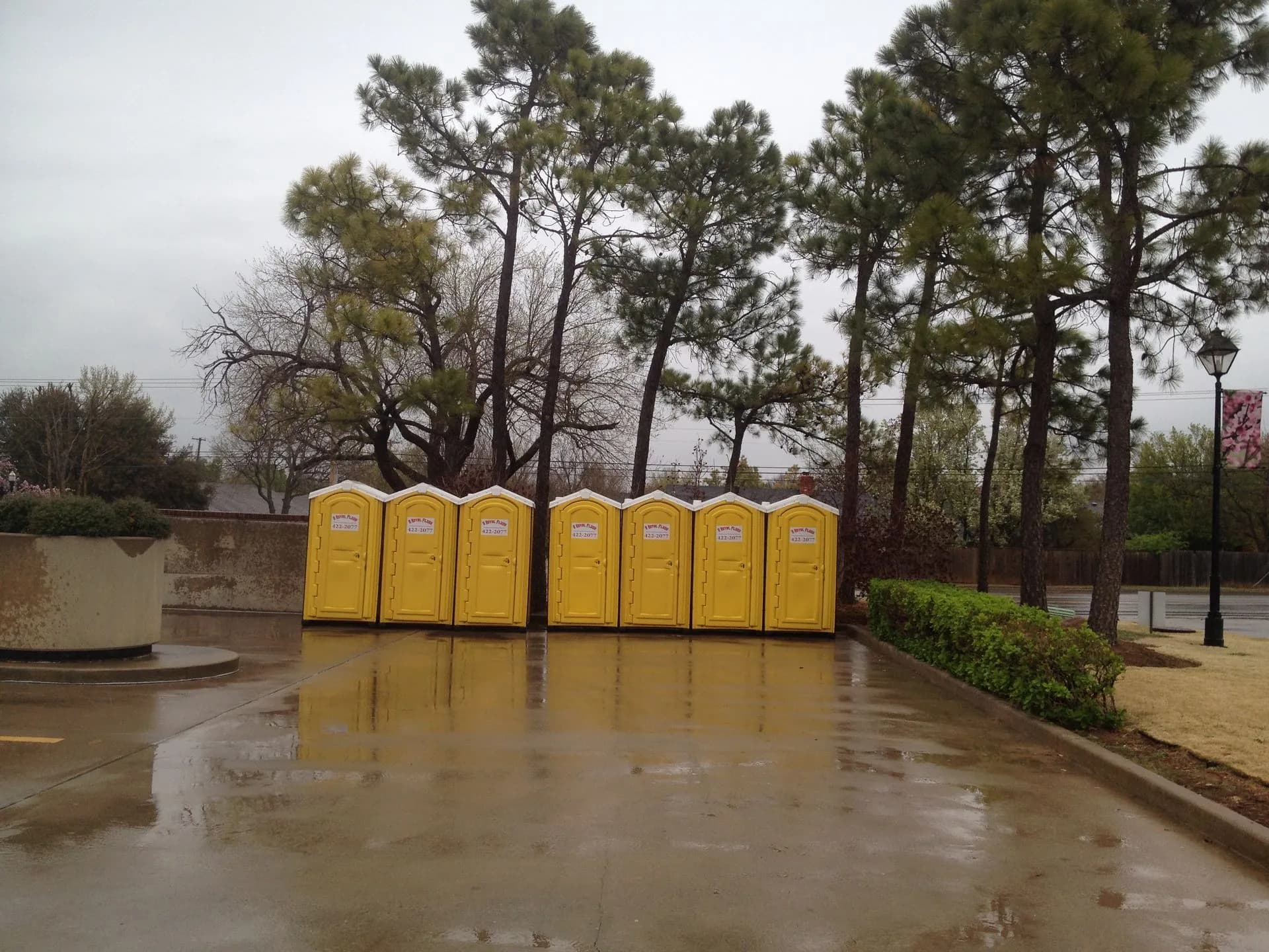 Portable restrooms placed in a city park after a rain