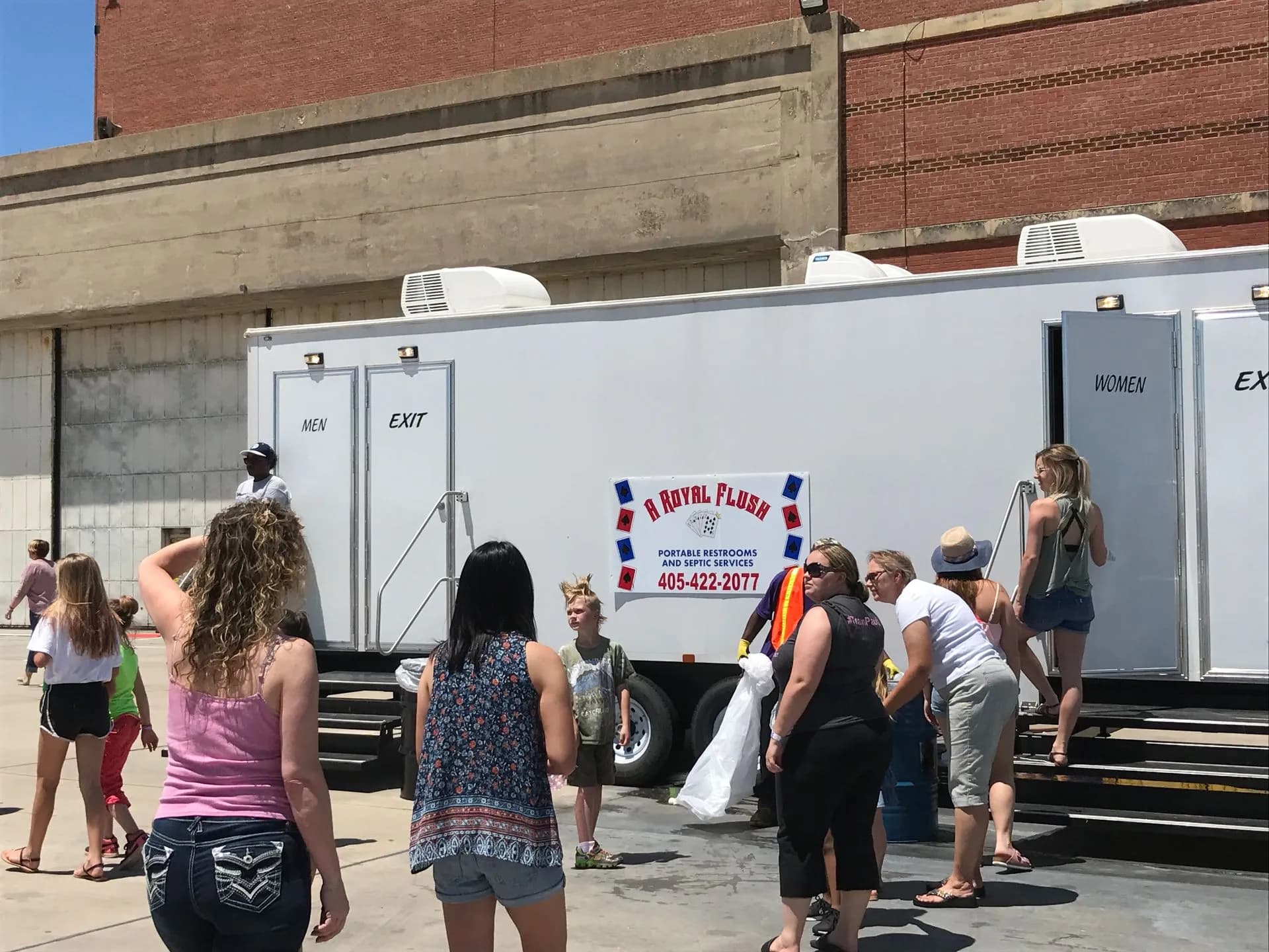 Event guests lining up at an A Royal Flush VIP restroom trailer